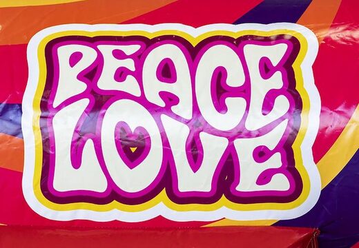 Opblaasbaar luchtkussen met glijbaan in hippy thema met veel kleuren kopen 
